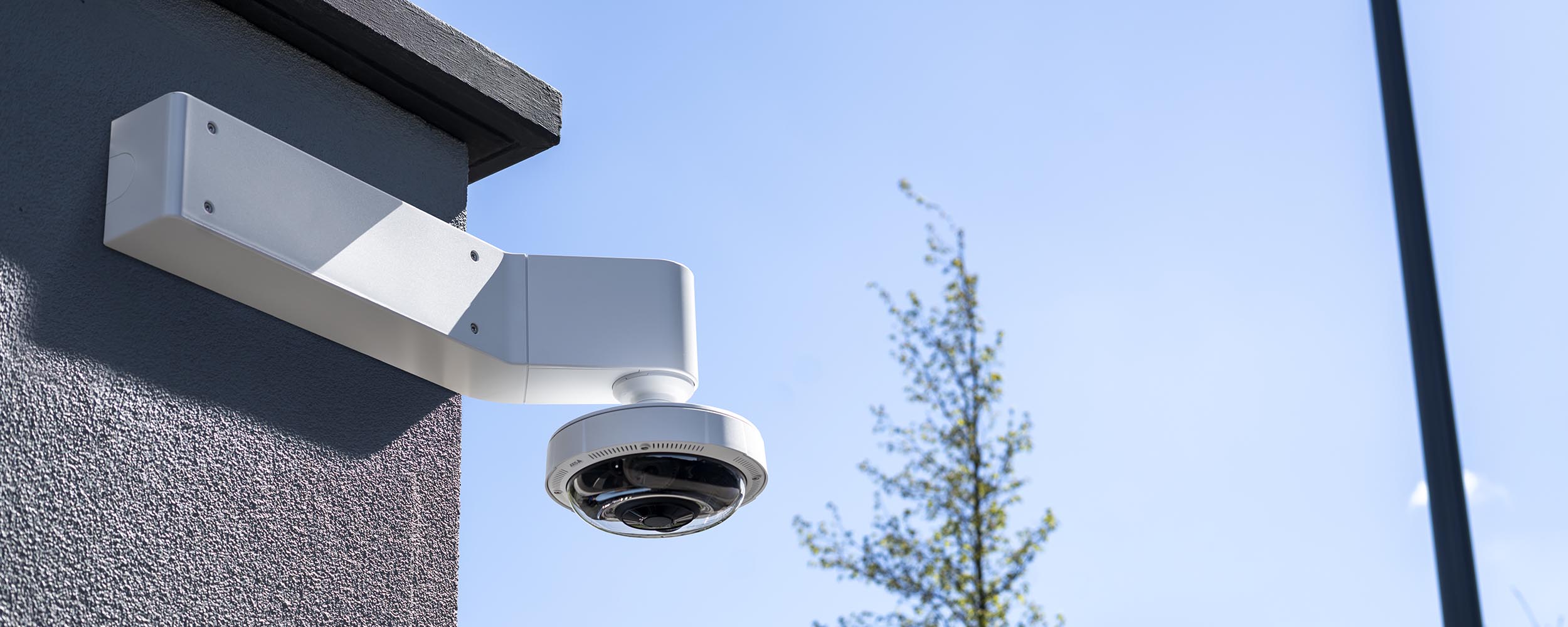 AXIS P3737-PLE Video Camera on an exterior wall mount.